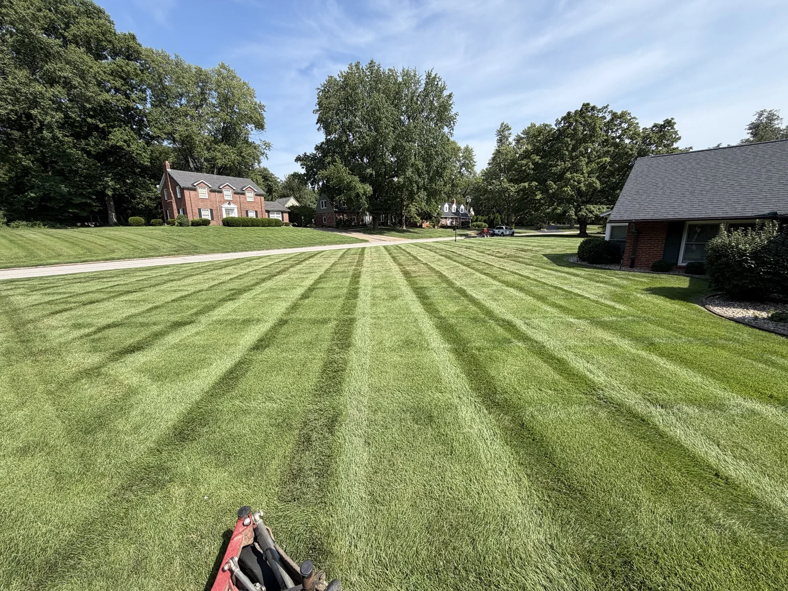 Freshly striped lawn maintained by Double A Lawn Care